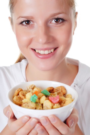 portrait of young woman with plate of muesliの写真素材