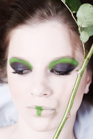 Portrait of beautiful young girl, with the green stem of rose with sharp thornsの写真素材