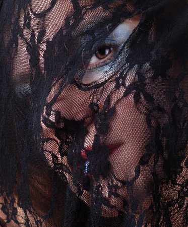 woman face in a mask of black lace の写真素材