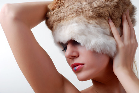 beautiful young model dressed in a fur hatの写真素材