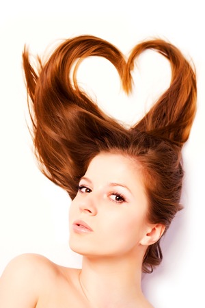 portrait of woman with long hair in shape of heartの写真素材