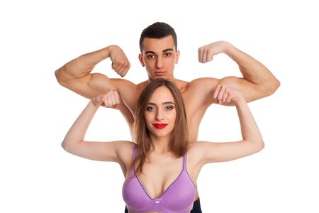 Girlfriend and boyfriend showing their muscles in studioの写真素材