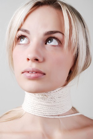 portait of beautiful woman with the white rope on the neckの写真素材