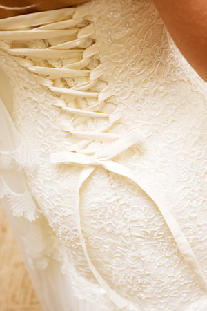 brides back in wedding white dress with laceの写真素材