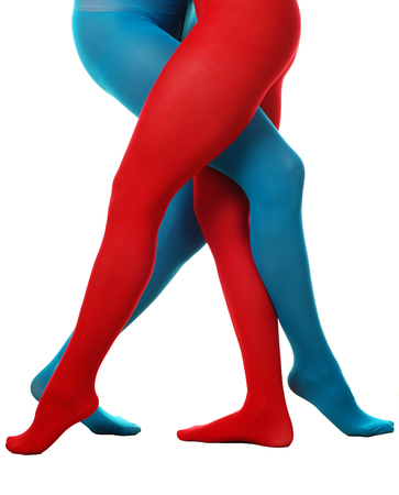 beautiful legs of two women in red and blue tights
