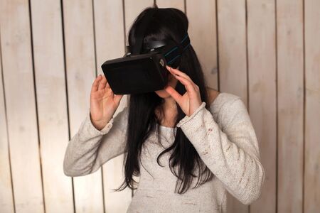 Woman in virtual reality helmet. VR glasses.