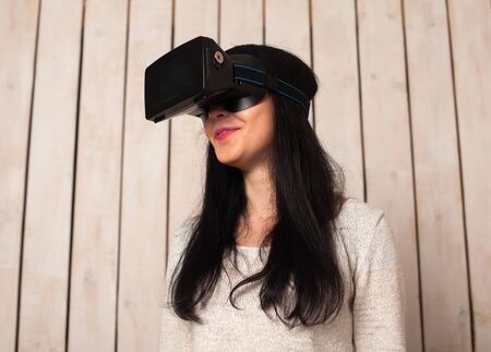Woman in virtual reality helmet. VR glasses.の写真素材