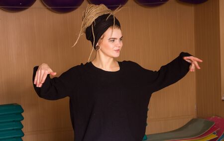 The dancer is posing in movement in the dance studio
