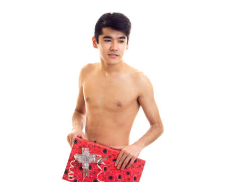 Undressed young man holding presentの写真素材