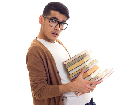 Young man in glasses with booksの写真素材
