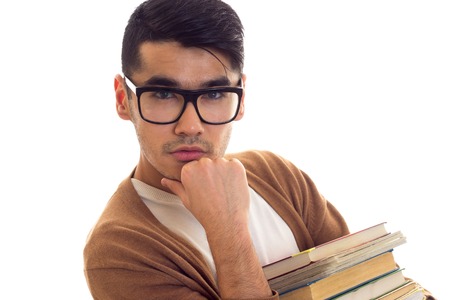 Young man in glasses with booksの写真素材
