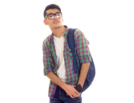 Young man with backpack and smartphoneの写真素材