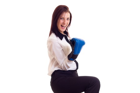 Young businesswoman in boxing glovesの写真素材