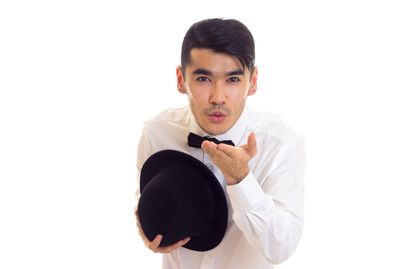 Young man in white T-shirt with black hatの写真素材