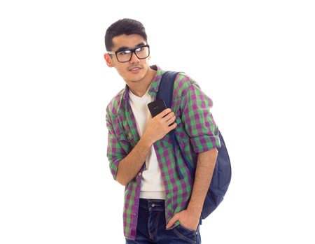 Young man with backpack and smartphoneの写真素材