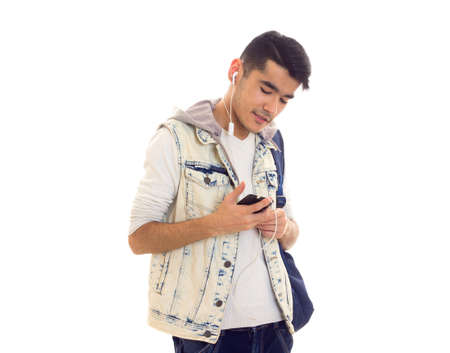Young man with backpack, smartphone and headphonesの写真素材