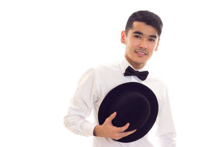 Young man in white T-shirt with black hatの写真素材