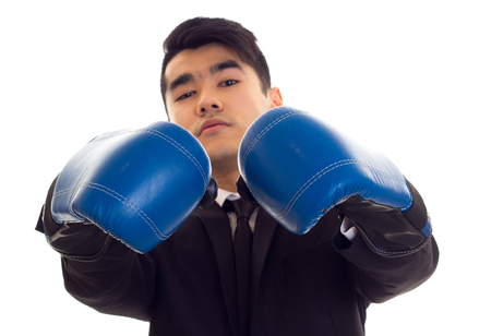 Young man in suit with boxing glovesの写真素材