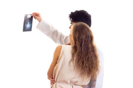 Doctor showing X-ray to young womanの写真素材