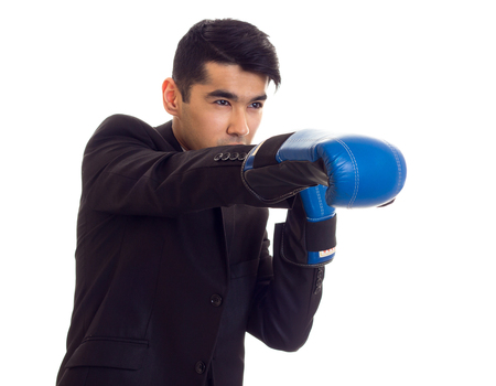 Young man in suit with boxing gloves