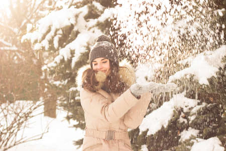 Young woman playing with snowの写真素材