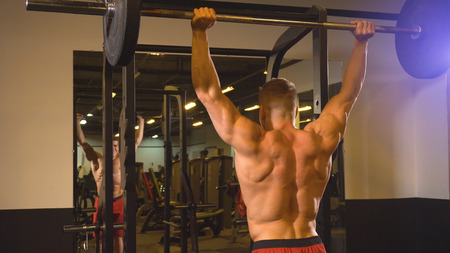 Man training with barbell in the gym