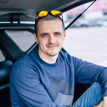 Man with sunglasses on his head looking in camera