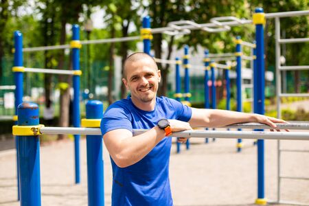 Athlete at sports ground looking in camera and smiling