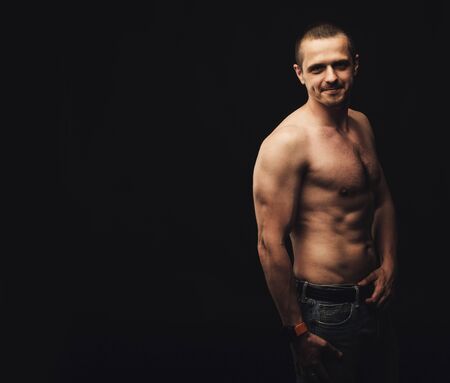 Man with naked natural athletic body looking in cameraの写真素材
