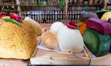 Various types of cheese on the table in the storeの写真素材