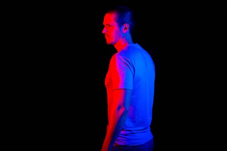 Man standing in studio under red and blue color lightsの写真素材