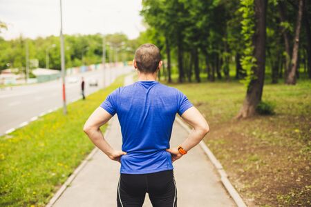 Back of man who preparing for hard run workoutの写真素材