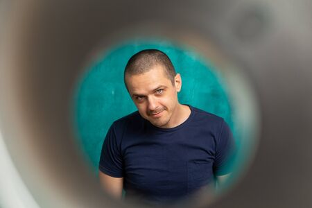 Adult man looking through some tube in cameraの写真素材