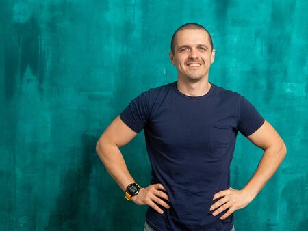 Portrait of man in dark t-shirt looking in camera and smilingの写真素材