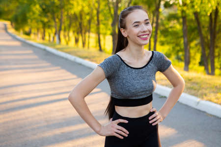 Closeup portrait of sporty athletic woman in sportswear smiling in camera.の写真素材