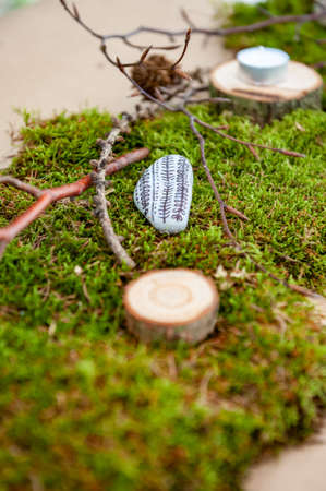 Summer wedding decoration made of moss, branches, thistle, stones, meadow flowers, wood and...