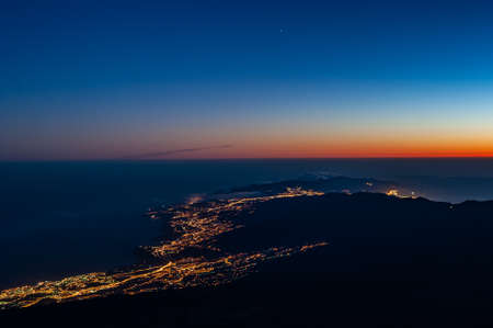 Tenerife coastline lights at dawn before sunrise from Pico del Teide mountain in El Teide National park. Tenerife, Canary Islands, Spainの写真素材
