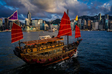 Hong Kong, China - 19 June, 2010: Traditional Chinese junk boat crossing Victoria Harborのeditorial素材
