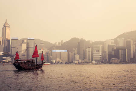Hong Kong, China - 27 September, 2012: Traditional Chinese junk boat crossing Victoria Harborのeditorial素材