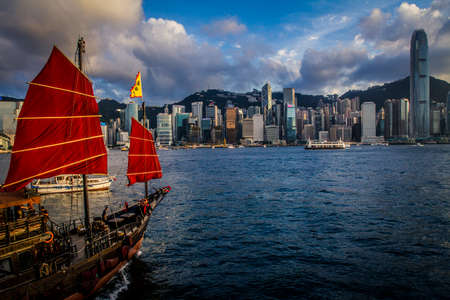 Hong Kong, China - 19 June, 2010: Traditional Chinese junk boat crossing Victoria Harborのeditorial素材