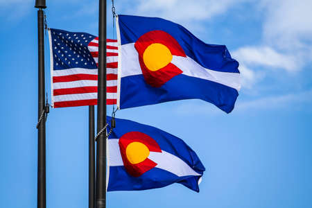 Colorado and USA flags with blue sky backgroundの写真素材