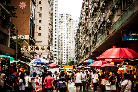Hong Kong, China - 7 July, 2013: People on a very busy street next to the tram station in North point District on Hong Kong Islandのeditorial素材