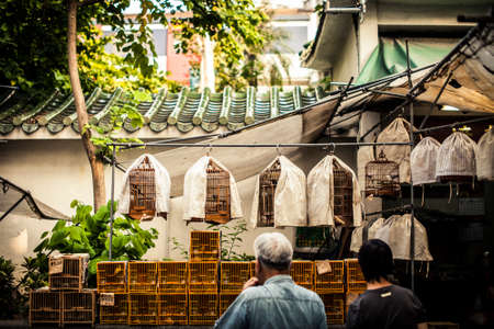 Hong Kong, China - October 10, 2010: Shoppers examining the cages at the Yuen Po Bird Garden in Mongkok districtのeditorial素材