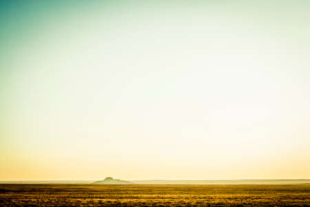Desert landscape with a distant rocky peakの写真素材