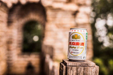 Beijing, China - 4 September, 2013: Yangjing beer sitting on a wooden post at the Jianko section of the Great Wallのeditorial素材