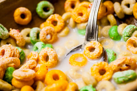Breakfast cereal in a bowl with milk and a spoon