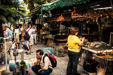 Hong Kong, China - October 10, 2010: Shoppers examining the cages at the Yuen Po Bird Garden in Mongkok districtのeditorial素材