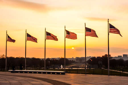 American flag set against a sunset in Washington D.C.のeditorial素材