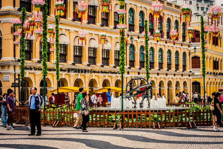 Macau, China - 9 June, 2009: Street scenes with local people along Rue de Campo in historic old town Macauのeditorial素材