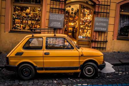 Prague, Czech Republic - 3 January, 2008: An old yellow Skoda parked in front of a shop selling tourist items in downtown Pragueのeditorial素材